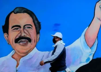 Reuters A man walks by a mural depicting Nicaraguan President Daniel Ortega, in Managua