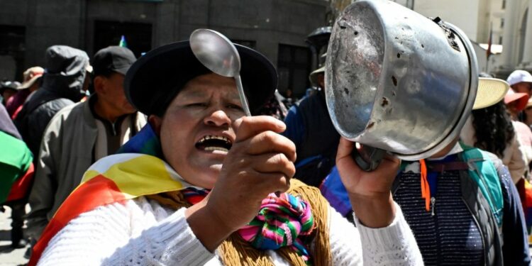 A supporter of Bolivia's former president, Evo Morales, bangs a pot during the ‘Communal for Life’ march against the government of Luis Arce and to denounce the economic crisis outside the vice-presidency building in La Paz on January 13, 2025.