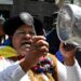 A supporter of Bolivia's former president, Evo Morales, bangs a pot during the ‘Communal for Life’ march against the government of Luis Arce and to denounce the economic crisis outside the vice-presidency building in La Paz on January 13, 2025.