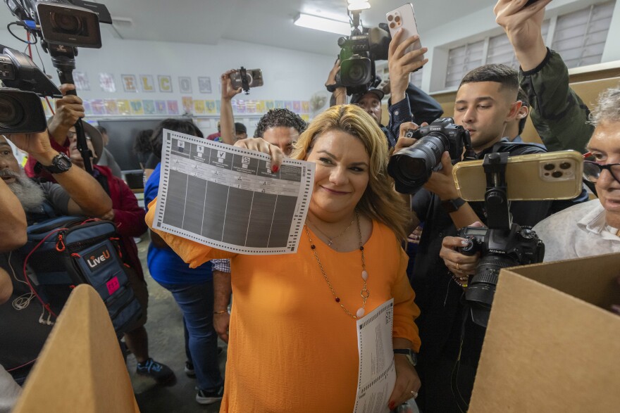 Jenniffer González, Puerto Rico's New Progressive Party candidate for Governor, shows her ballot during general elections in San Juan, Puerto Rico, Tuesday, Nov. 5, 2024.