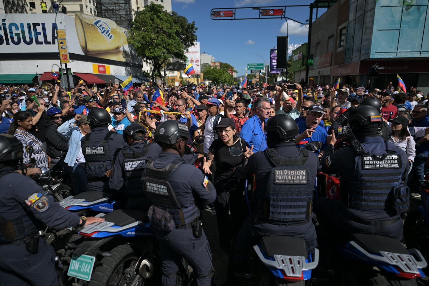 Motorized police officers tried to ride through the demonstration in Caracas.