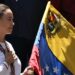 Venezuelan opposition leader María Corina Machado holds a Venezuelan national flag as she gestures from atop a truck during a demonstration to protest over the presidential election results, in Caracas on August 3, 2024.