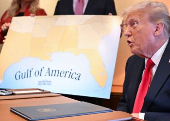 Trump at a table with a map titled