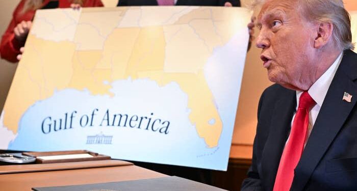 Trump at a table with a map titled