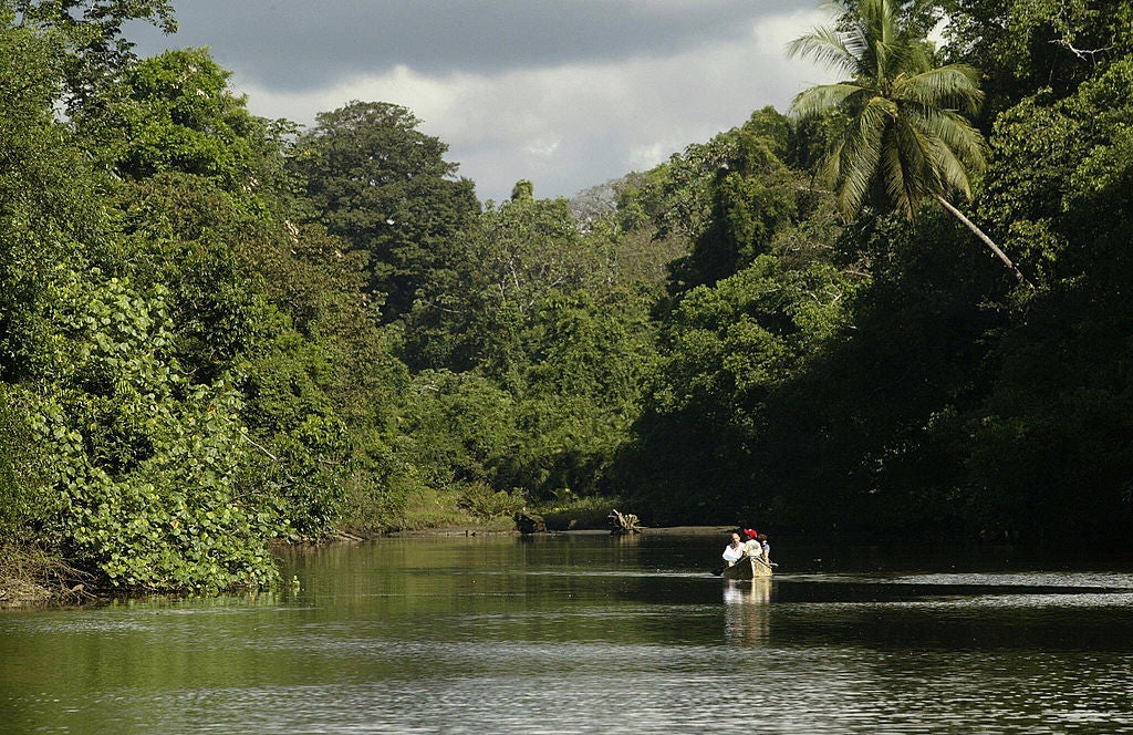 Tourists sail along the Sirena River in Corcovado National Park in Costa Rica