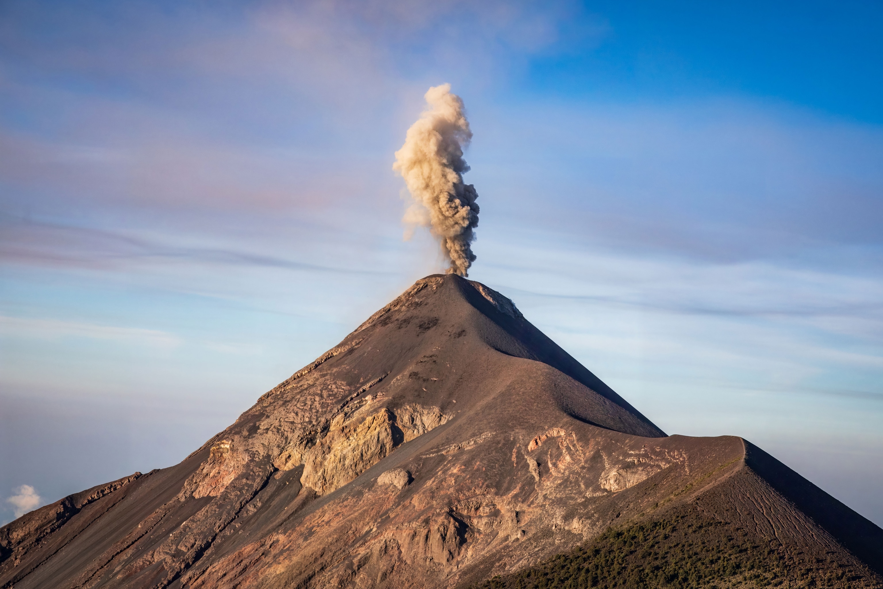 Volcán de Fuego, one of the most active in the world, with a cloud of billowing smoke, as seen from nearby Volcán Acatenango.