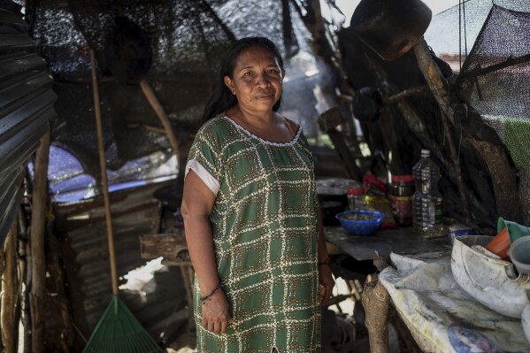 Rosa Elena Gonzalez, 45, an Indigenous woman from the Wayuu community, poses for the photo in her kitchen in the Somos Unidos neighborhood on the outskirts of Maicao, Colombia, Wednesday, Feb. 5, 2025. (AP Photo/Ivan Valencia)