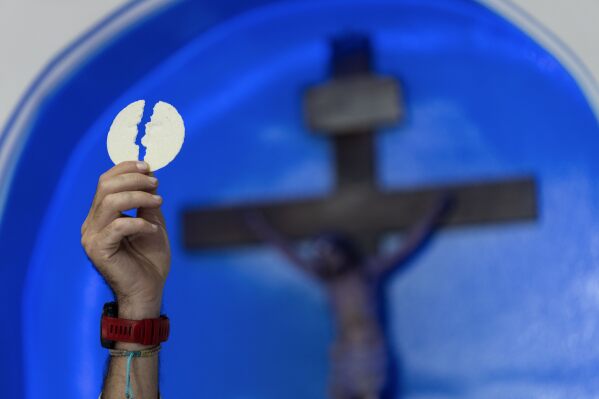 Priest Agustin Lopez leads a Mass for the health of Pope Francis at Caacupe church in the Carlos Mugica neighborhood in Buenos Aires, Argentina, Sunday, Feb. 23, 2025. (AP Photo/Rodrigo Abd)