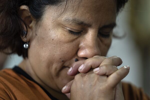 A woman prays at the Rosario church in Carlos Mugica neighborhood, Buenos Aires, Argentina, Sunday, Feb. 23, 2025. (AP Photo/Rodrigo Abd)