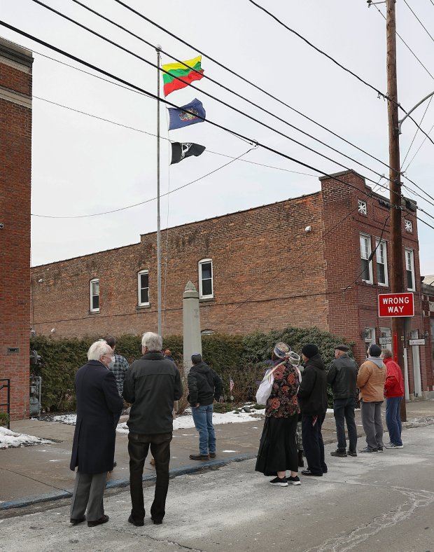 Pittston Facilities Manager Ron Faraday raises the Lithuanian Flag during...