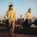 Workers carry equipment during the construction of the Nestor Kirchner gas pipeline.