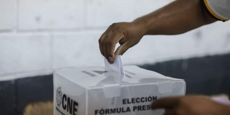 Hand places vote in voting box