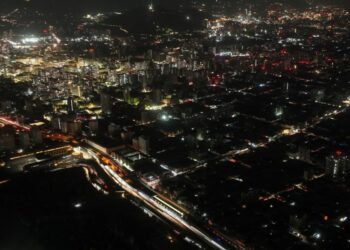 This aerial view shows the city partially illuminated during a blackout in Santiago on February 25, 2025.