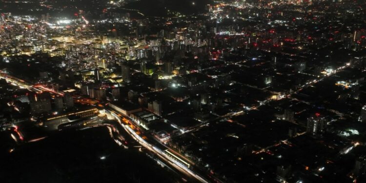 This aerial view shows the city partially illuminated during a blackout in Santiago on February 25, 2025.