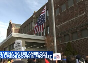 Father Michael Pfleger flies American flag upside-down outside Saint Sabina Church in Gresham, Chicago