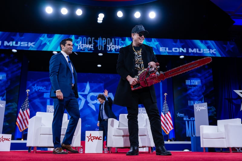 Elon Musk on stage with a chainsaw gifted to him by president Javier Milei of Argentina during the 2025 Conservative Political Action Conference. Photograph: Eric Lee/The New York Times
                      