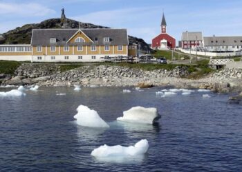 Small pieces of ice float in the water off the shore in Nuuk, Greenland. (AP Photo/Keith Virgo)
