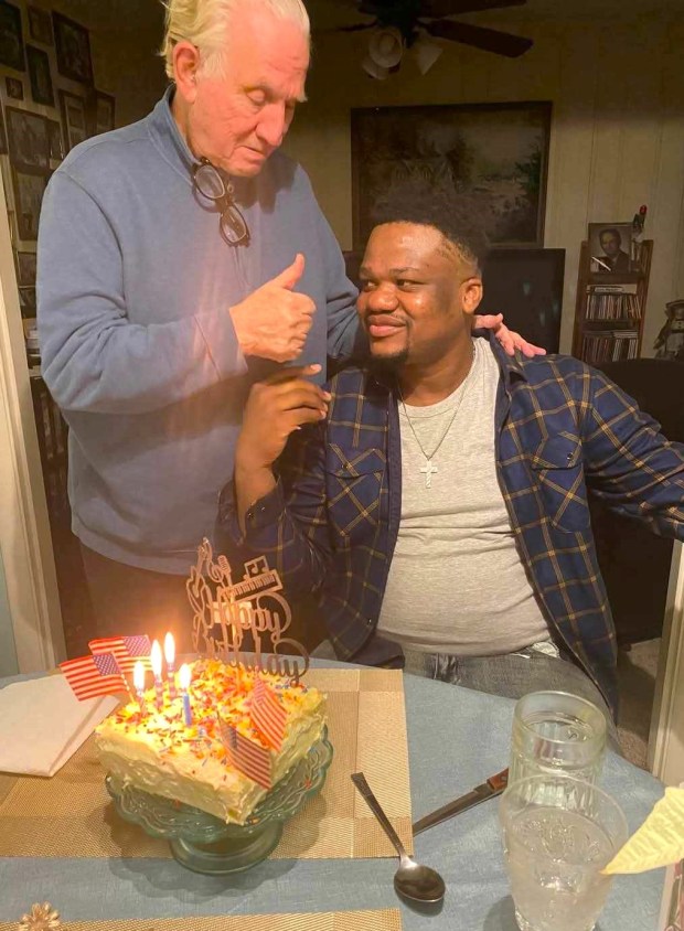 Dieusson Louis, right, and Richard Riel, the Haitian man's adopted mother's life partner at her home in Leominster. (COURTESY PHYLLIS MASTON)